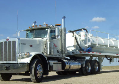 White tank truck with a Fruitland pump